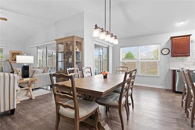 dining room with lofted ceiling and dark hardwood / wood-style floors