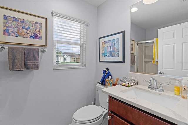 bathroom with vanity, toilet, and an enclosed shower