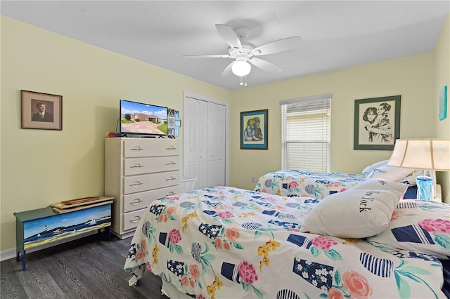 bedroom featuring ceiling fan, a closet, and dark wood-type flooring