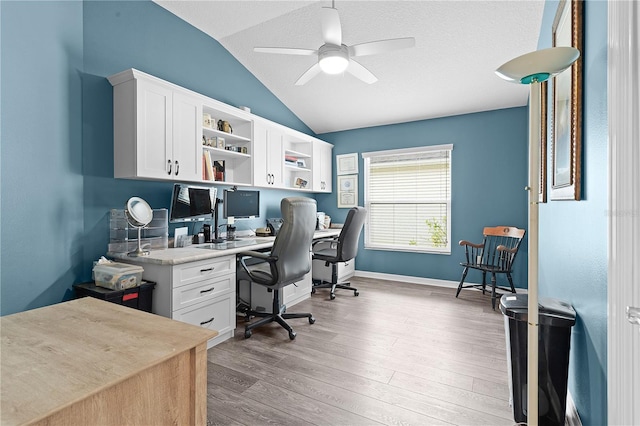 office area featuring lofted ceiling, ceiling fan, hardwood / wood-style flooring, and a textured ceiling