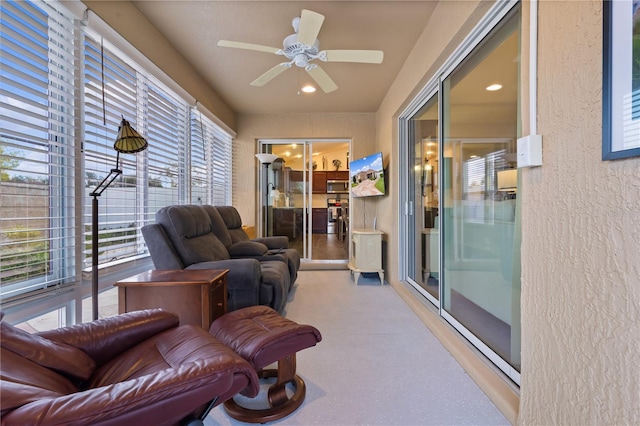 sunroom featuring ceiling fan