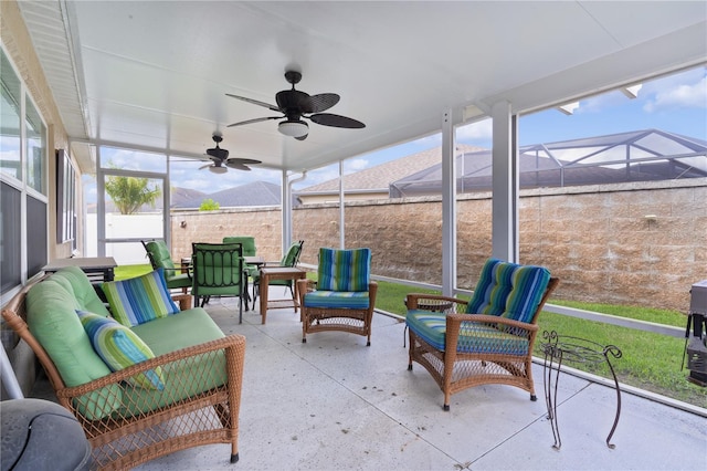 sunroom featuring ceiling fan