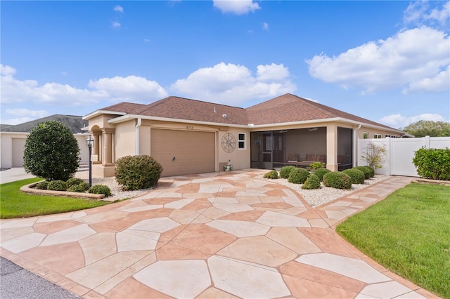 view of front of house featuring a front yard and a garage