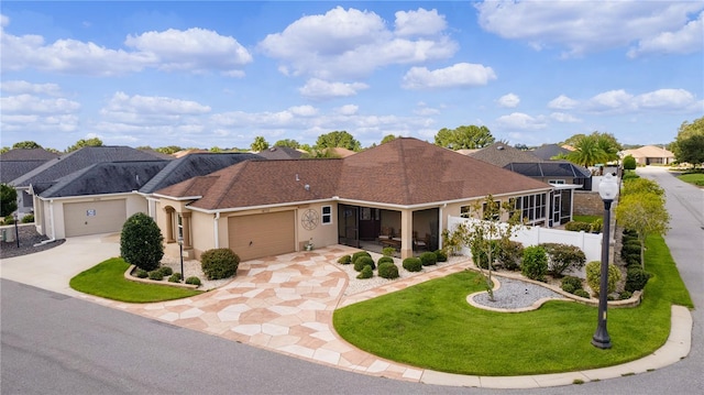 single story home featuring a front yard and a garage