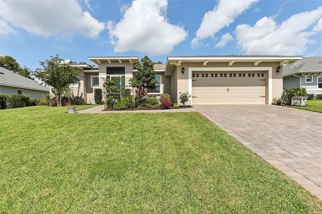 view of front of house featuring a garage and a front lawn