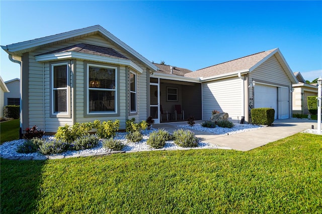 view of front of home with a front yard and a garage