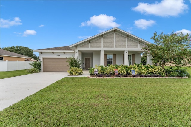 craftsman inspired home featuring a porch, a garage, and a front lawn