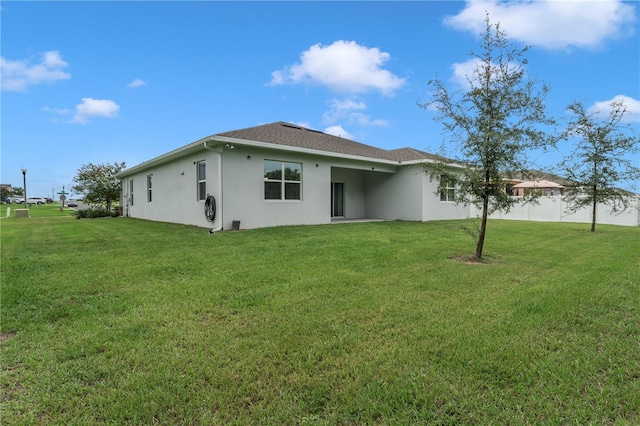 rear view of house with a yard