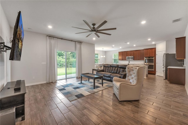 living room featuring ceiling fan and dark hardwood / wood-style flooring