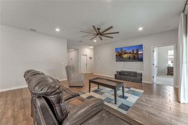 living room with ceiling fan and wood-type flooring