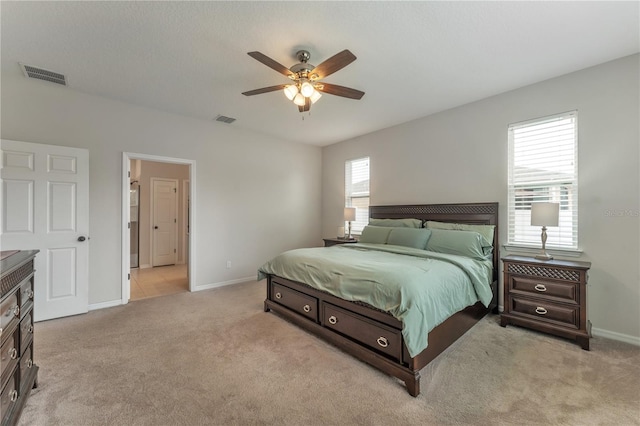 bedroom featuring light carpet, multiple windows, and ceiling fan