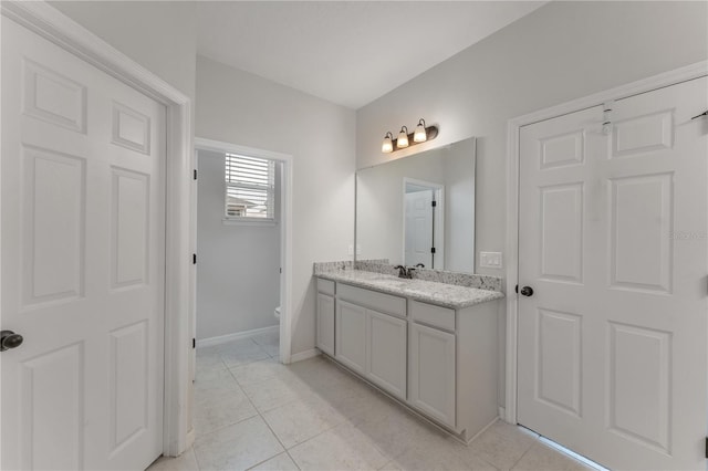 bathroom featuring vanity, toilet, and tile patterned floors