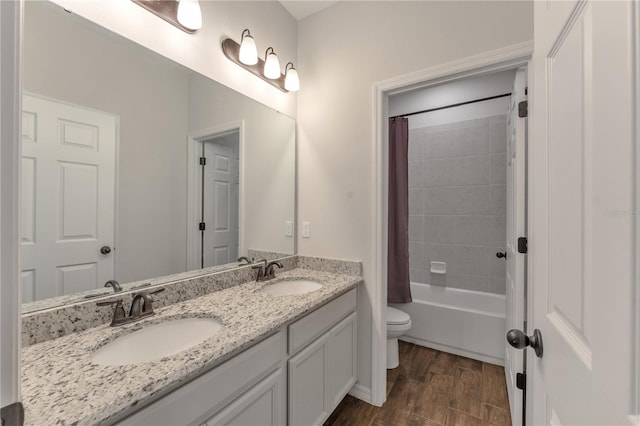 full bathroom featuring vanity, toilet, hardwood / wood-style flooring, and shower / bath combination with curtain