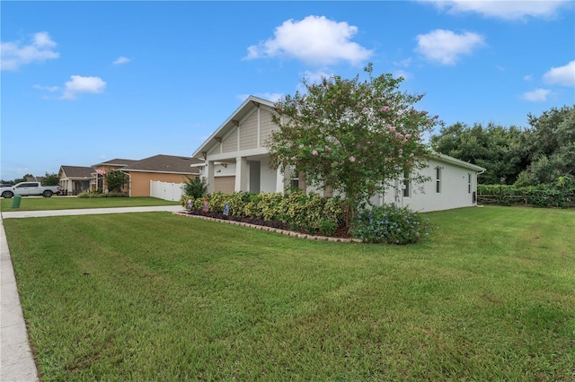 view of front facade featuring a garage and a front lawn