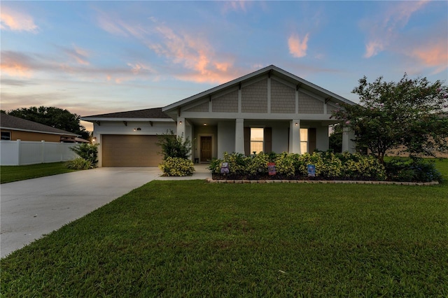 view of front of home with a lawn and a garage