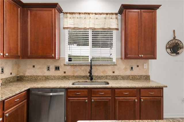 kitchen with dishwasher, tasteful backsplash, sink, and light stone countertops