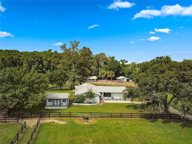 exterior space featuring a rural view and a yard