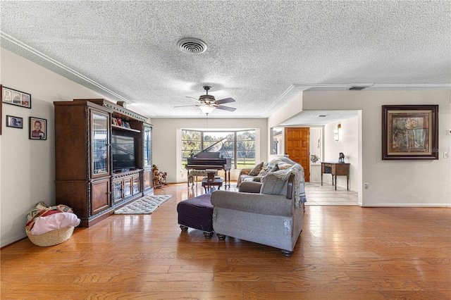 living room featuring ceiling fan, a textured ceiling, and light hardwood / wood-style floors