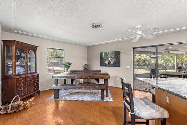 dining area featuring ceiling fan, a textured ceiling, and light hardwood / wood-style flooring