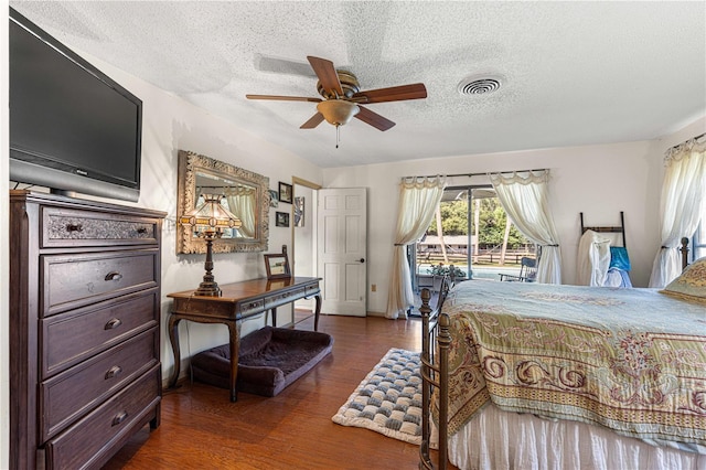 bedroom featuring a textured ceiling, dark hardwood / wood-style flooring, and ceiling fan