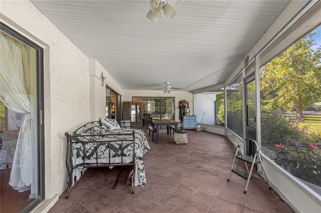 sunroom / solarium featuring ceiling fan and a wealth of natural light