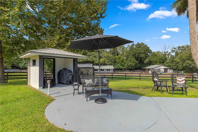 view of patio featuring area for grilling and a storage unit