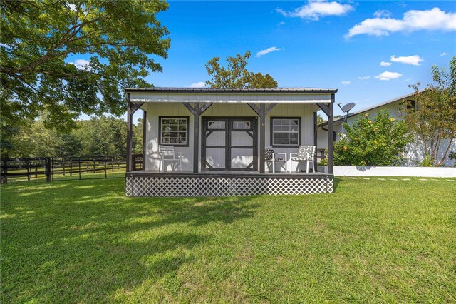 exterior space with an outdoor structure and a yard