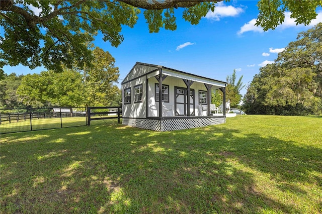 exterior space featuring a lawn and an outbuilding