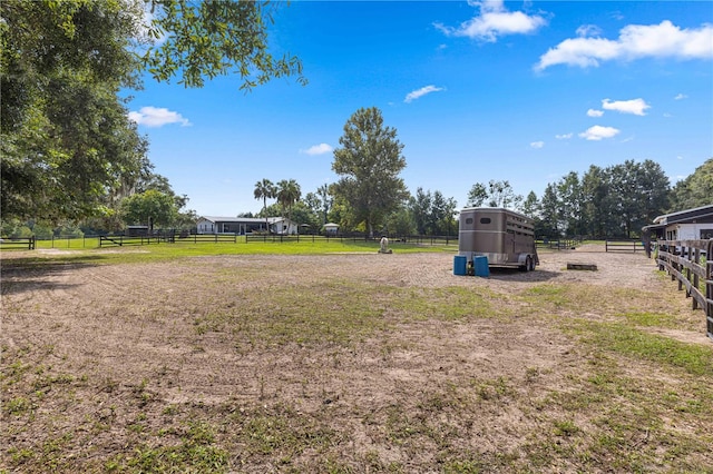 view of yard with an outbuilding and a rural view