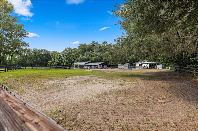 view of yard with a rural view