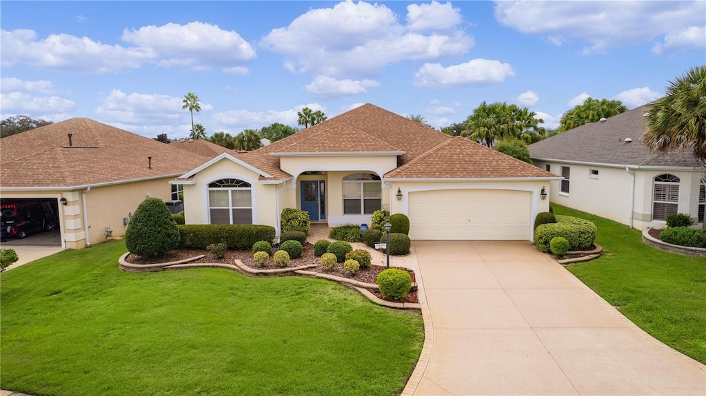 view of front of house featuring a garage and a front lawn