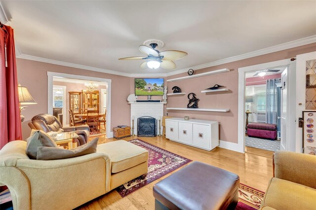 living room featuring plenty of natural light, light hardwood / wood-style flooring, and ceiling fan