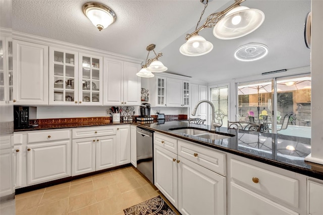 kitchen featuring a textured ceiling, sink, hanging light fixtures, stainless steel dishwasher, and white cabinets