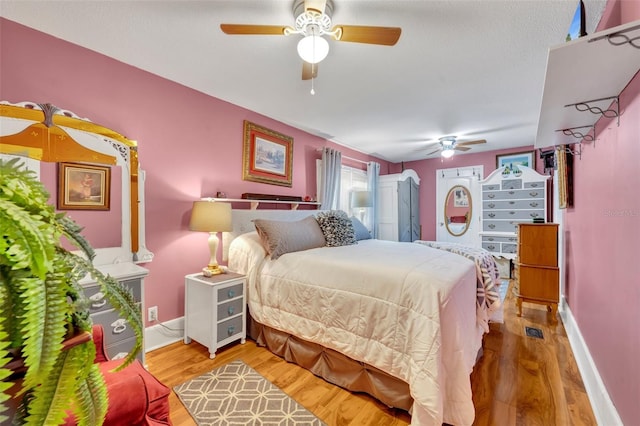 bedroom with wood-type flooring and ceiling fan