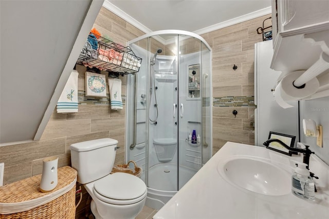 bathroom with tile walls, toilet, ornamental molding, and an enclosed shower