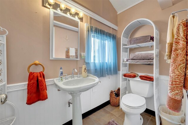 bathroom featuring lofted ceiling, toilet, and tile patterned floors