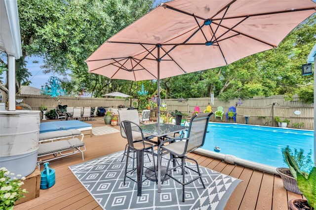 view of swimming pool featuring a wooden deck