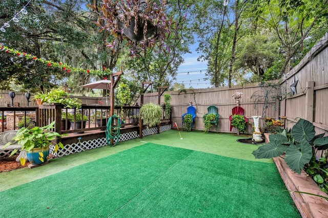 view of yard with a wooden deck