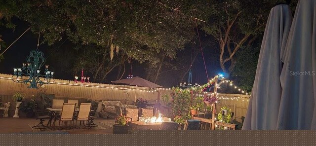 view of property's community featuring an outdoor living space with a fire pit