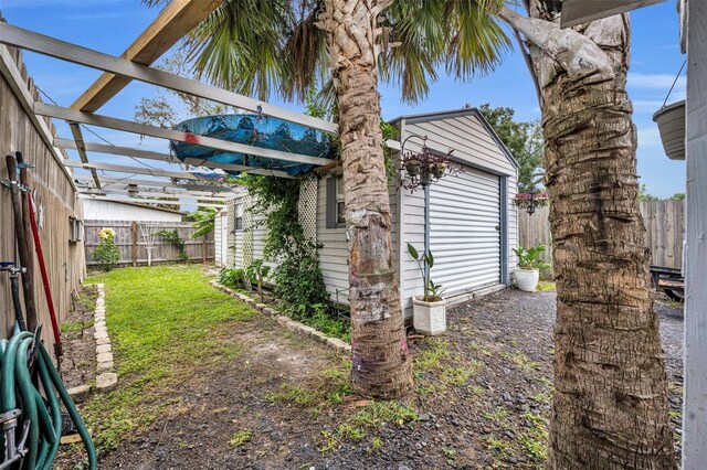 view of yard with an outbuilding and a pergola