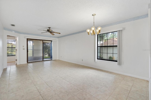 unfurnished room featuring a textured ceiling, ceiling fan with notable chandelier, light tile patterned floors, and plenty of natural light