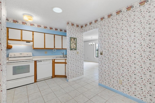 kitchen with light tile patterned floors, white cabinets, sink, and white appliances