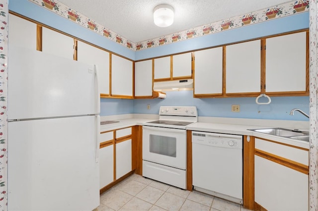 kitchen with white appliances, white cabinetry, a textured ceiling, and sink