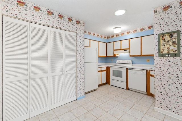 kitchen featuring white appliances, white cabinetry, and light tile patterned floors