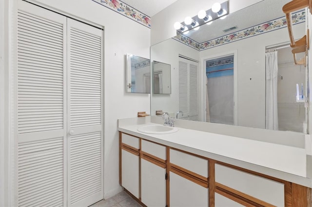 bathroom with vanity and tile patterned flooring