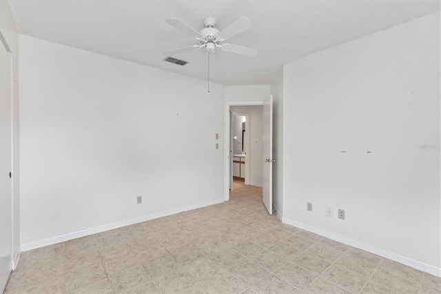 unfurnished room featuring a textured ceiling and ceiling fan