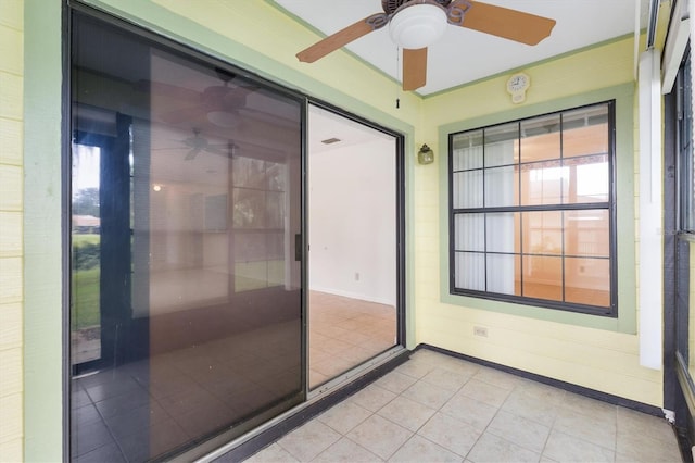 interior space with ceiling fan