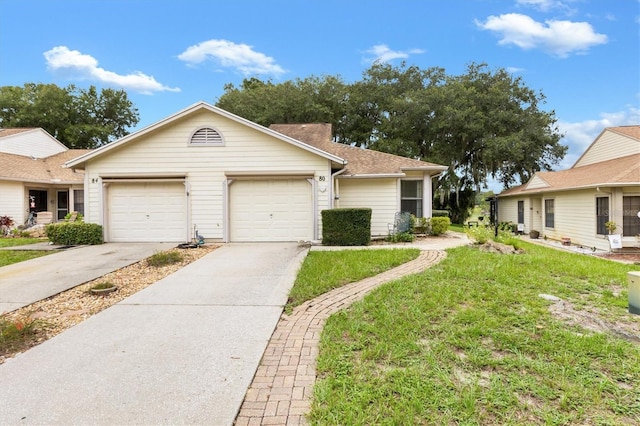 ranch-style house featuring a front lawn and a garage