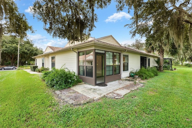 rear view of house with a yard