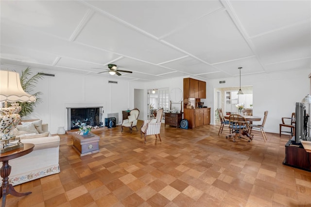 living room with plenty of natural light and ceiling fan